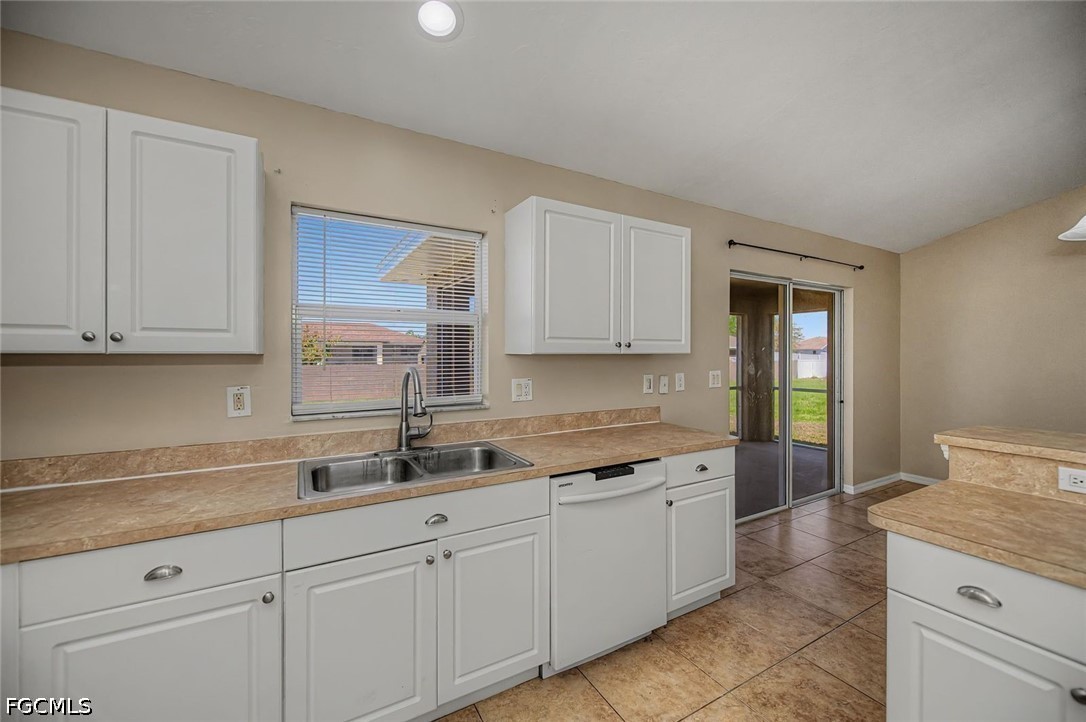 4104 13th Street Southwest Lehigh Acres, FL 33976 - Photo 8 of 46 a kitchen with white cabinets and sink