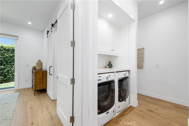 a view of a hallway with wooden floor and closet
