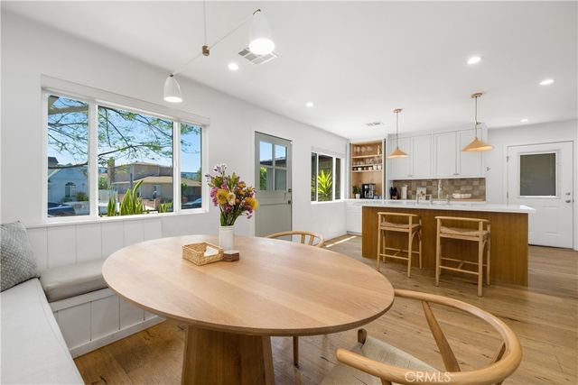 a kitchen with a table and chairs in it