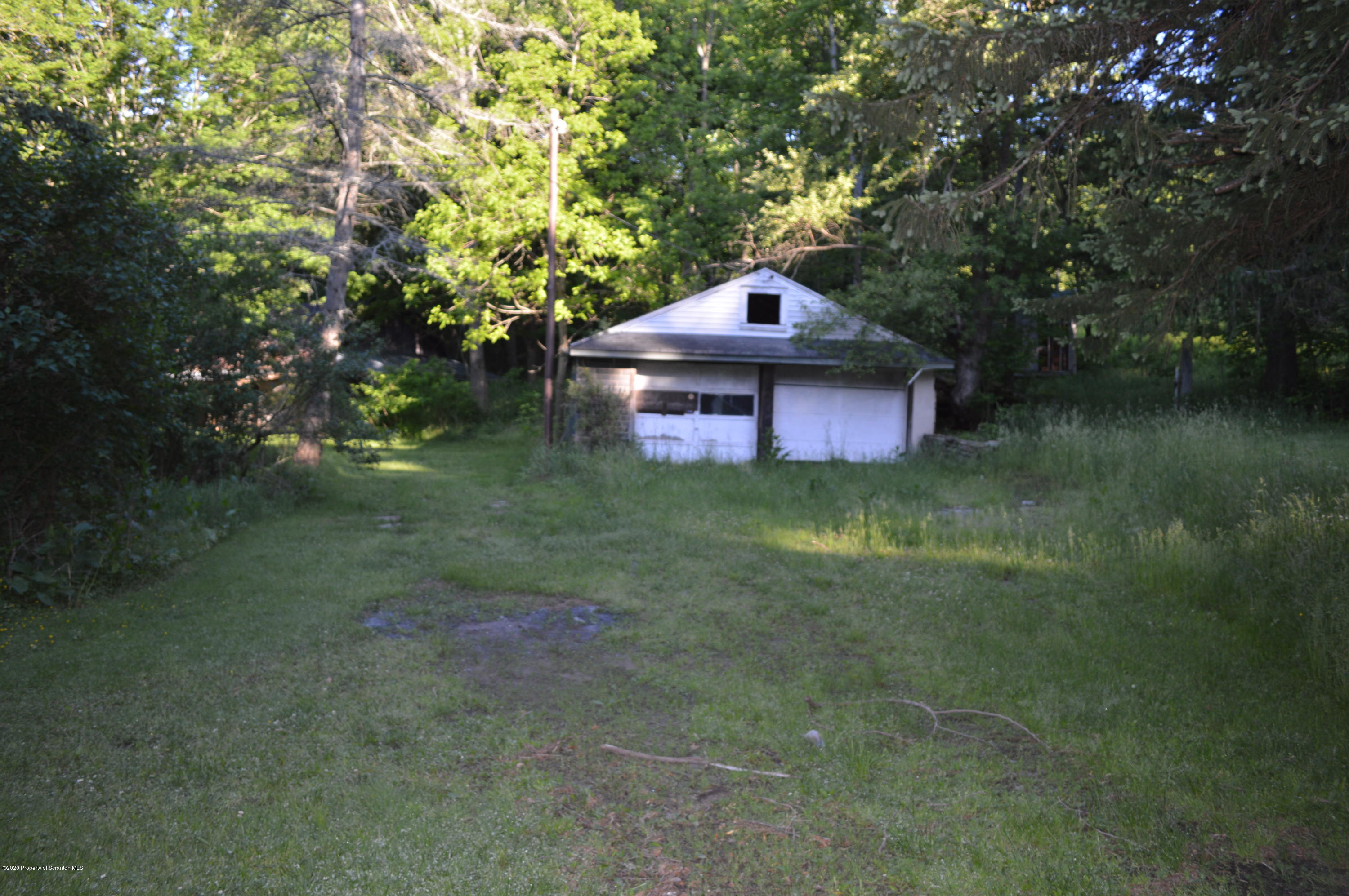 641 Becks Crossing Road Moscow, PA 18444 - Photo 3 of 28 a backyard of a house with table and chairs