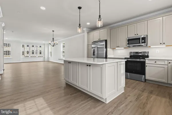 a kitchen with stainless steel appliances granite countertop a stove a sink dishwasher and a refrigerator with wooden floor