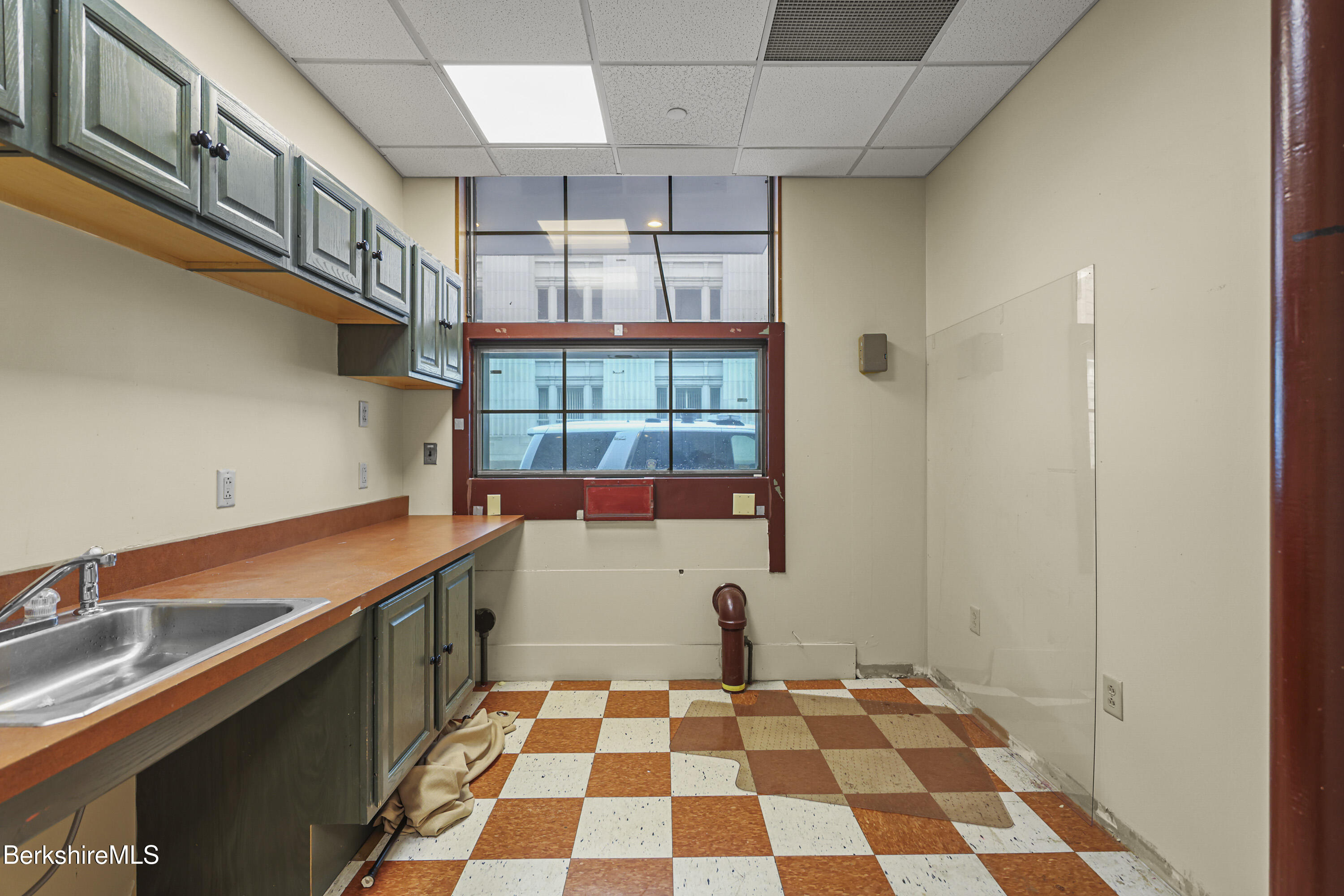 1 Fenn Street Pittsfield, MA 01201 - Photo 5 of 8 a room with a black white checkered floor and a dining table