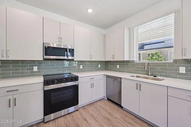 a kitchen with appliances cabinets and a sink