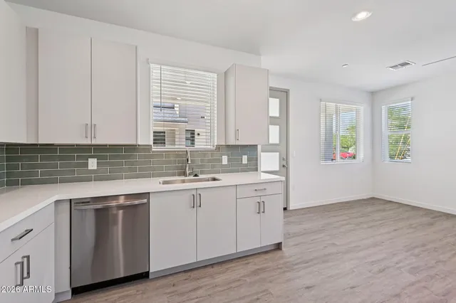 a view with cabinets wooden floor and a sink