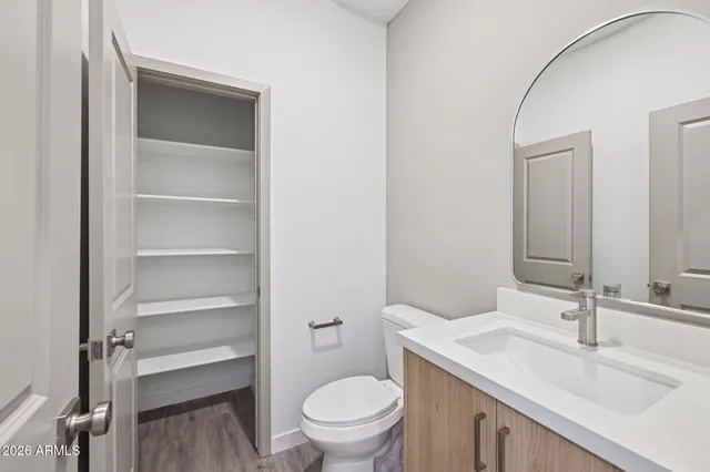 a bathroom with a sink a toilet and a mirror