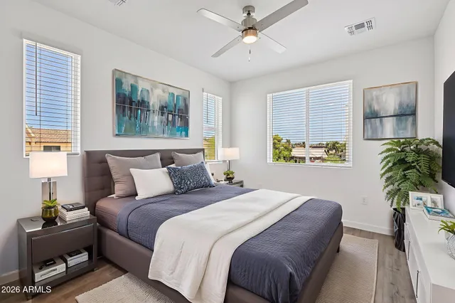 a bedroom with bed and a potted plant