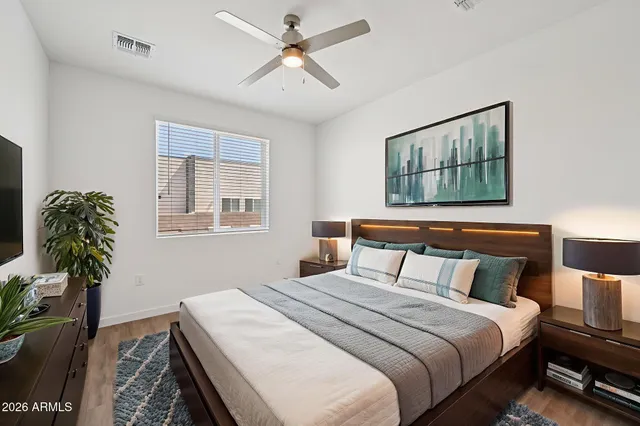 a bedroom with bed and a window