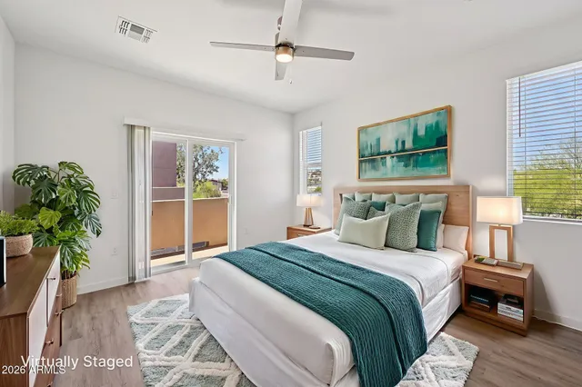 a bedroom with bed and a potted plant