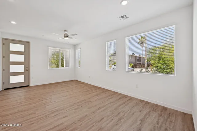 wooden floor in an empty room with a window