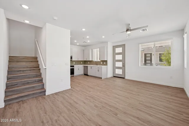 a view of a kitchen with wooden floor and a window