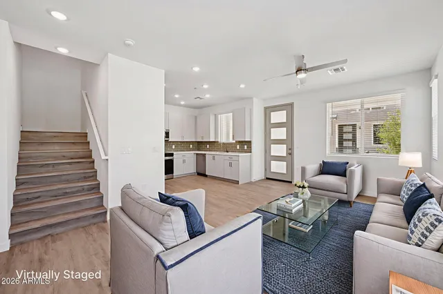 a living room with furniture and wooden floor