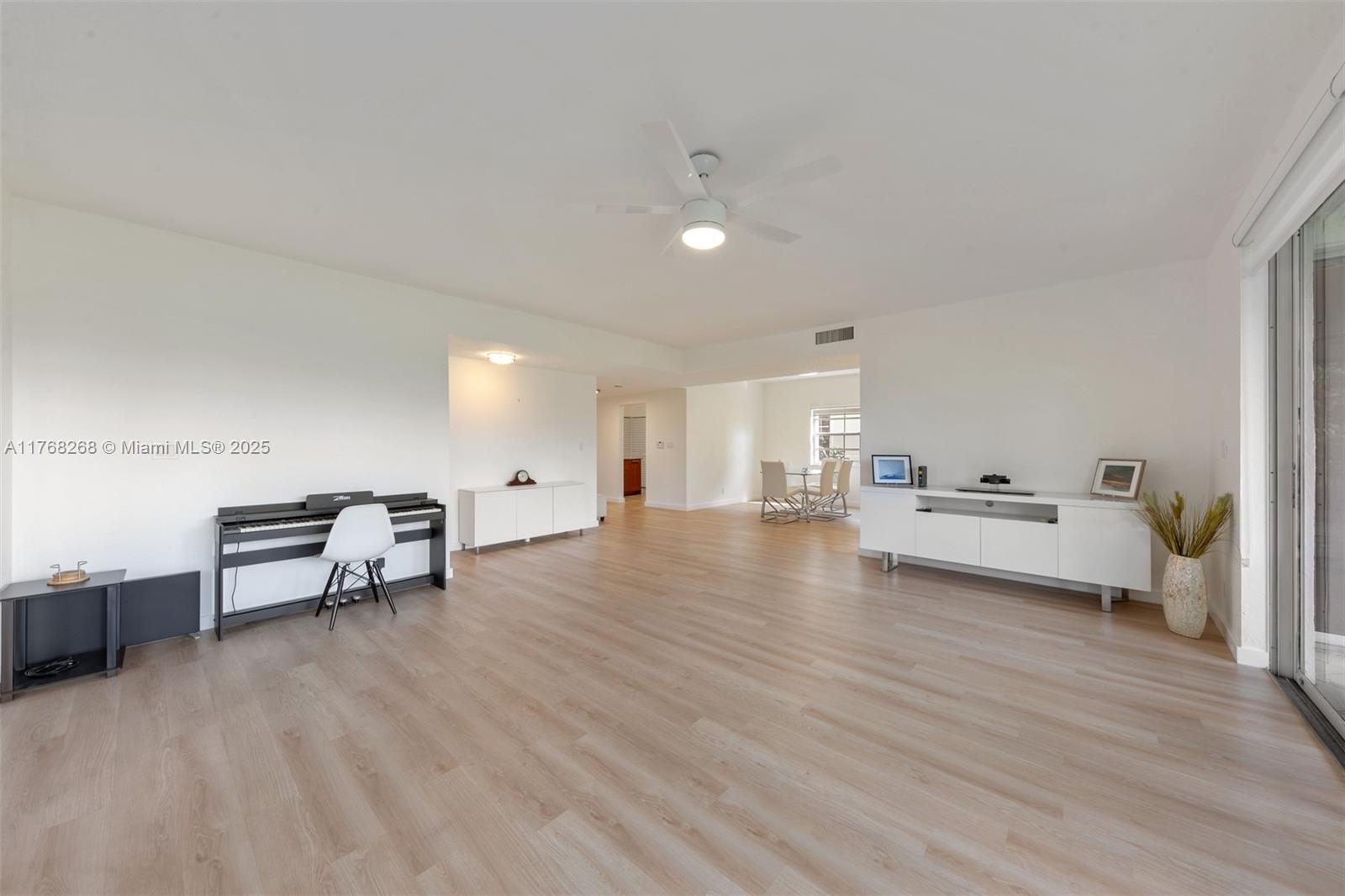 7658 Elm Ridge Drive, Unit 17U Boca Raton, FL 33433 - Photo 13 of 39 VIEW OF LIVING ROOM AND DINING ROOM. SHOWS HUGE VIEW OF LIVING SPACE