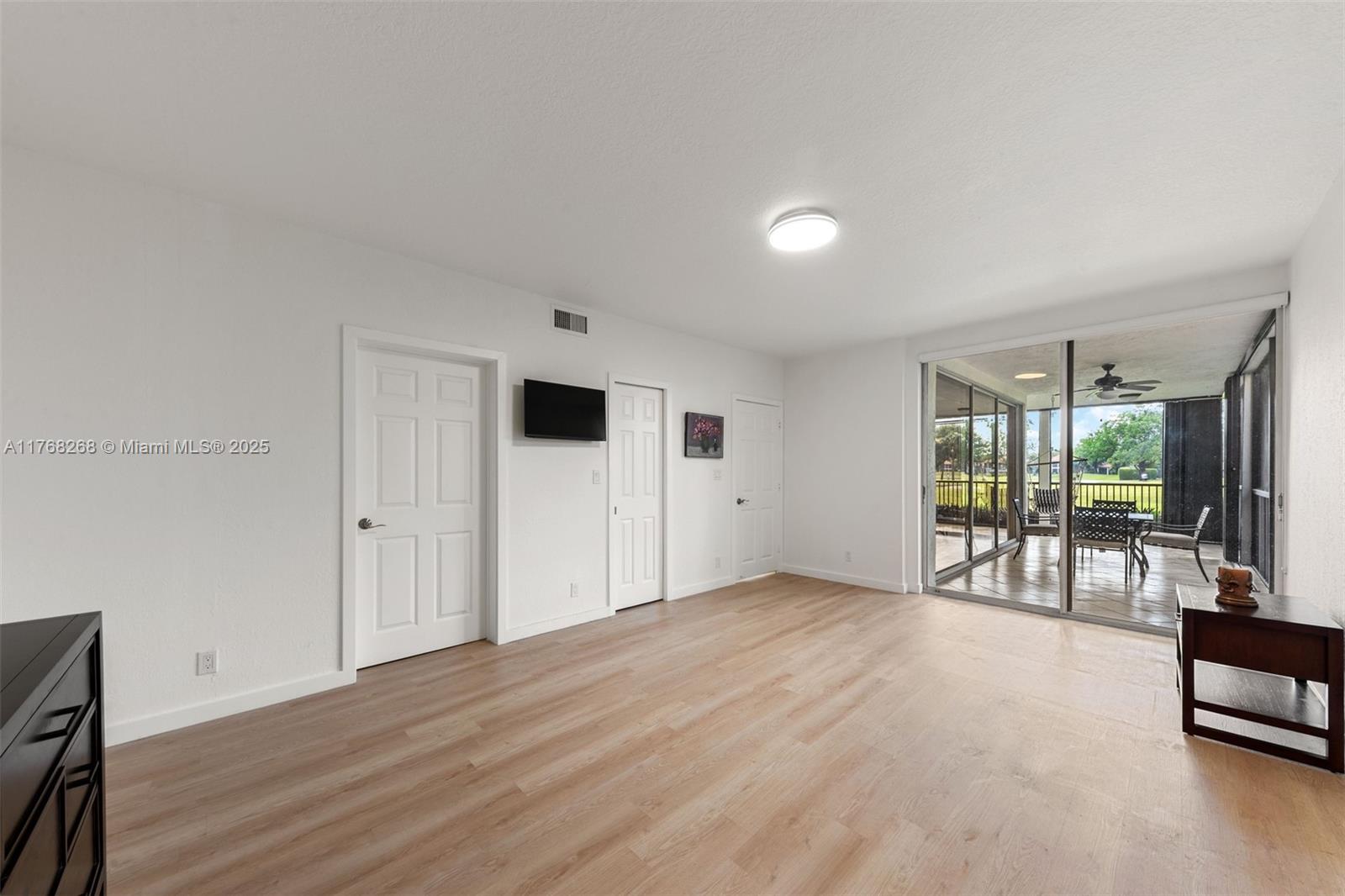 7658 Elm Ridge Drive, Unit 17U Boca Raton, FL 33433 - Photo 26 of 39 PRIMARY BEDROOM WITH WALK IN CLOSET AND VIEW OF GARDEN