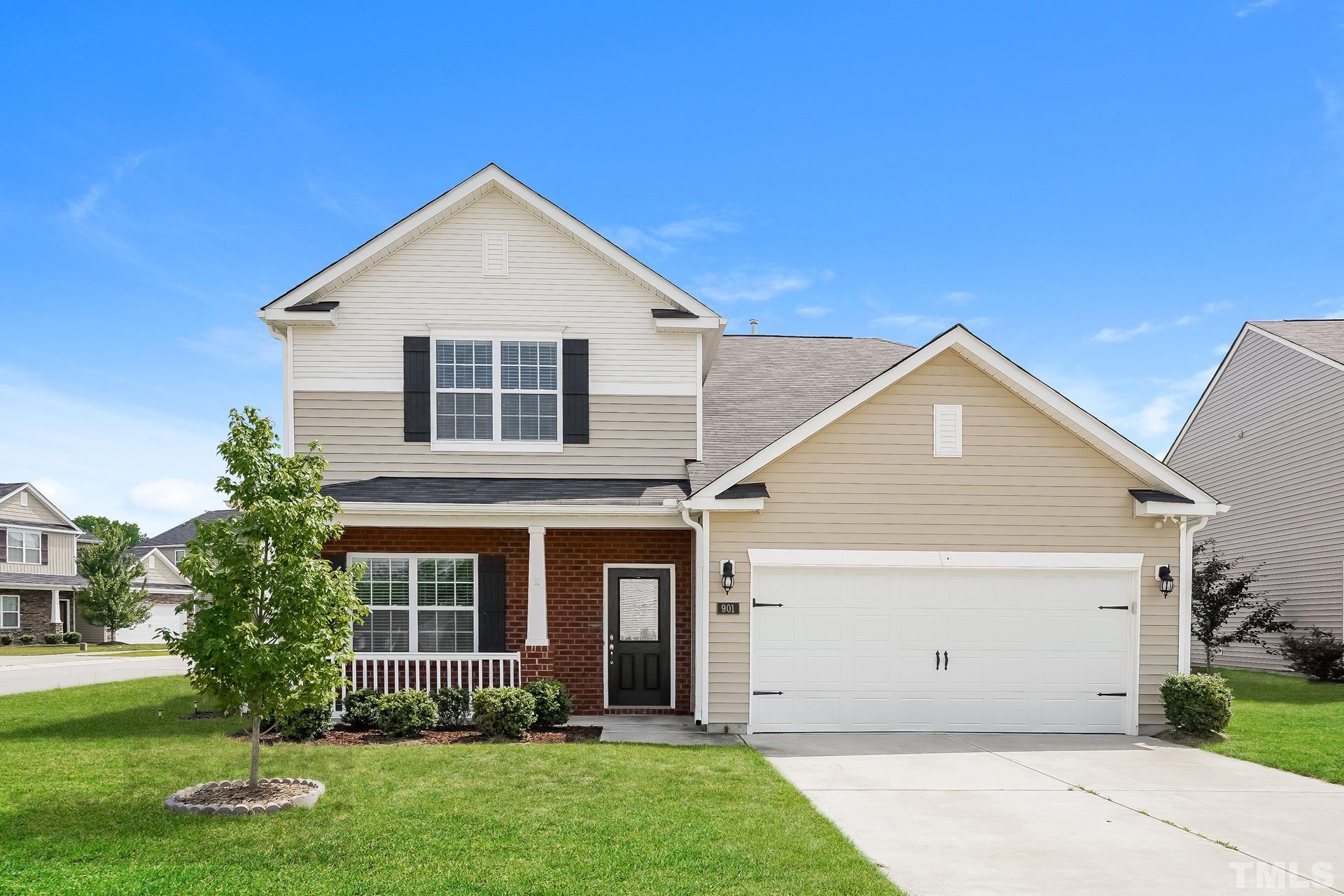 a front view of a house with a yard and garage