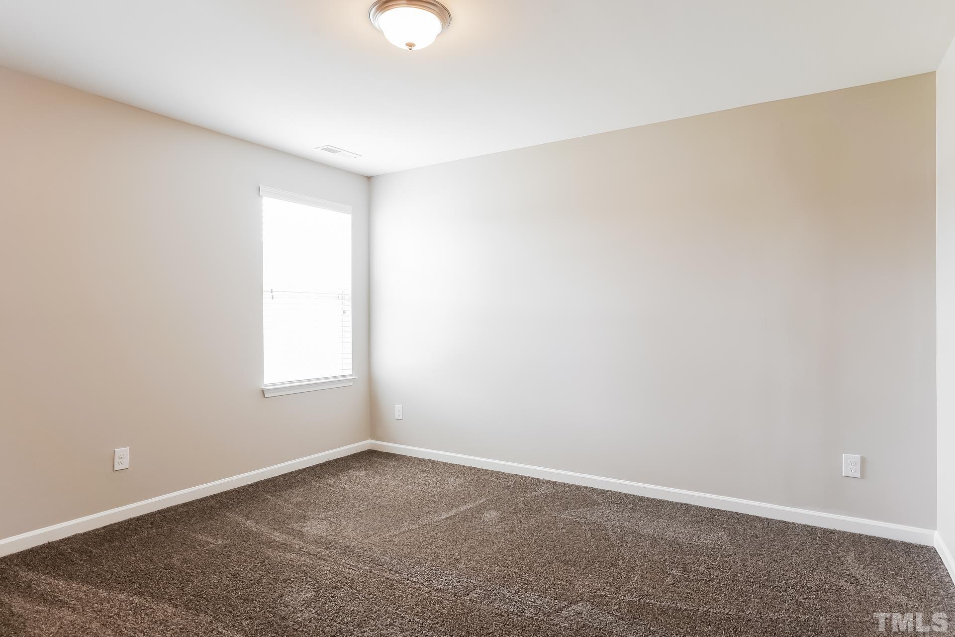 901 Rose Mallow Drive Zebulon, NC 27597 - Photo 12 of 15 an empty room with a window