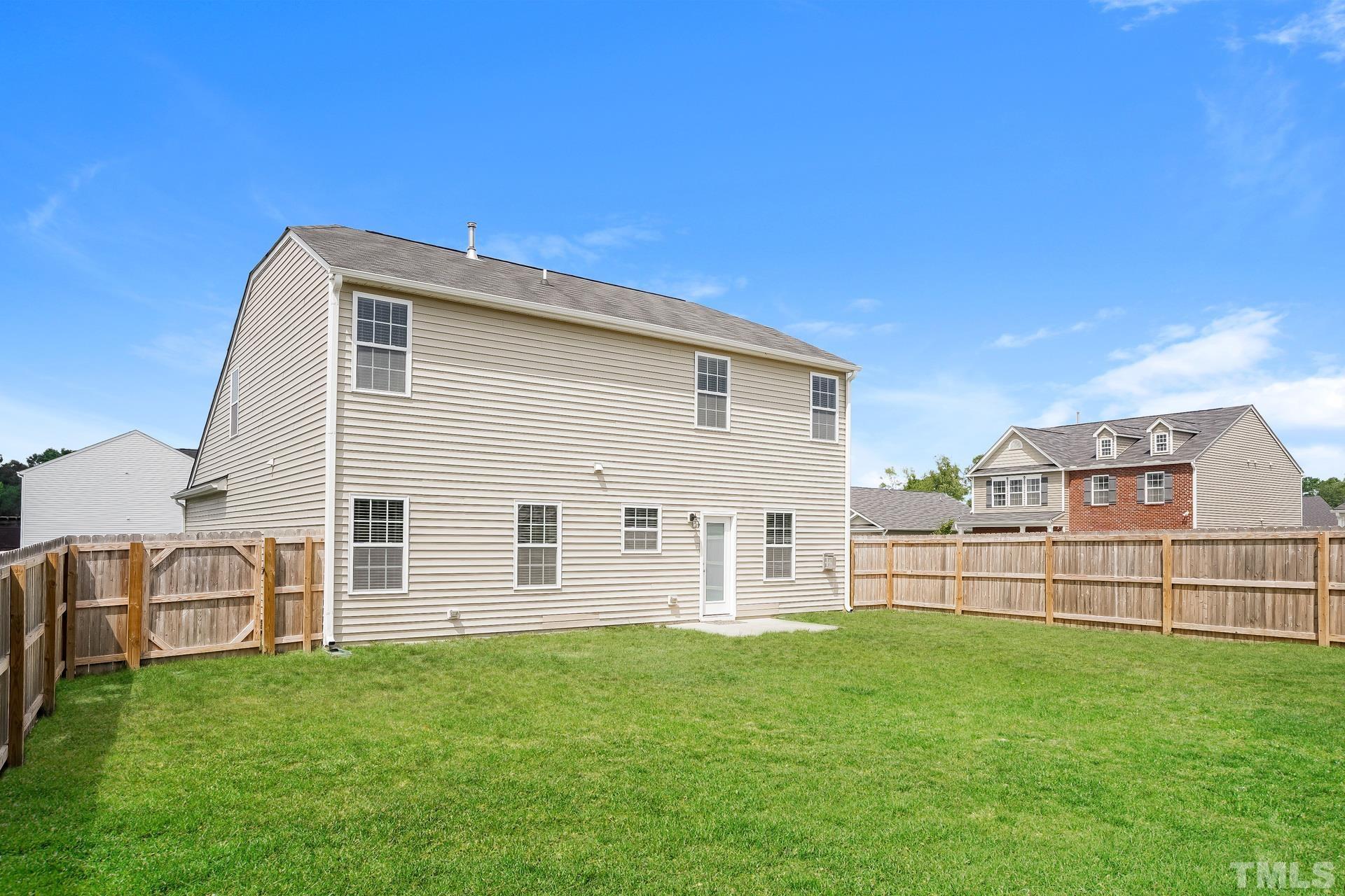 901 Rose Mallow Drive Zebulon, NC 27597 - Photo 15 of 15 a view of a house with a backyard
