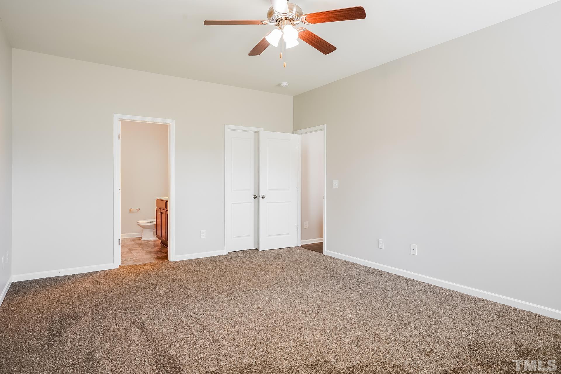 901 Rose Mallow Drive Zebulon, NC 27597 - Photo 7 of 15 a view of a big room with carpet and chandelier fan