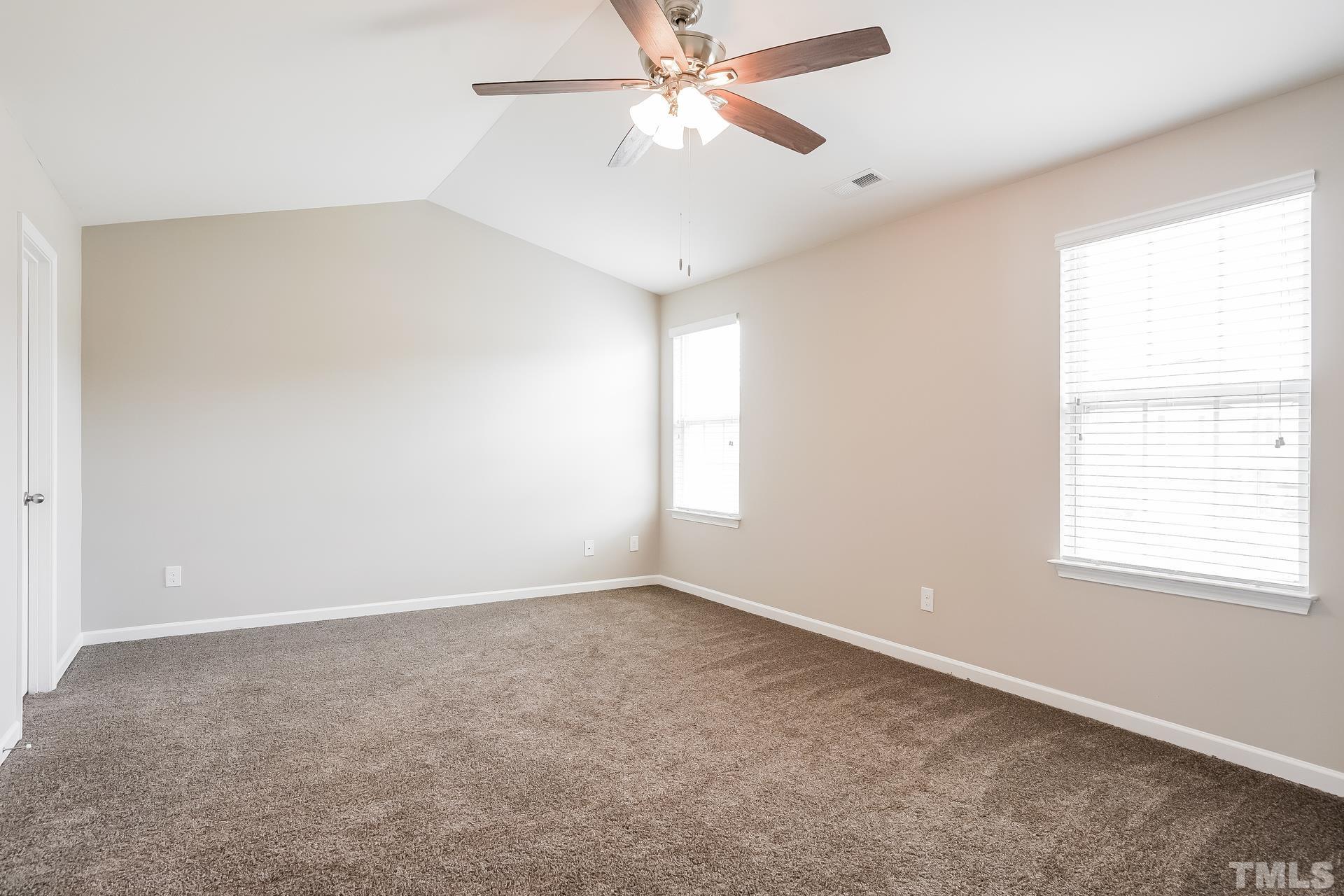 901 Rose Mallow Drive Zebulon, NC 27597 - Photo 8 of 15 an empty room with a window and a fan