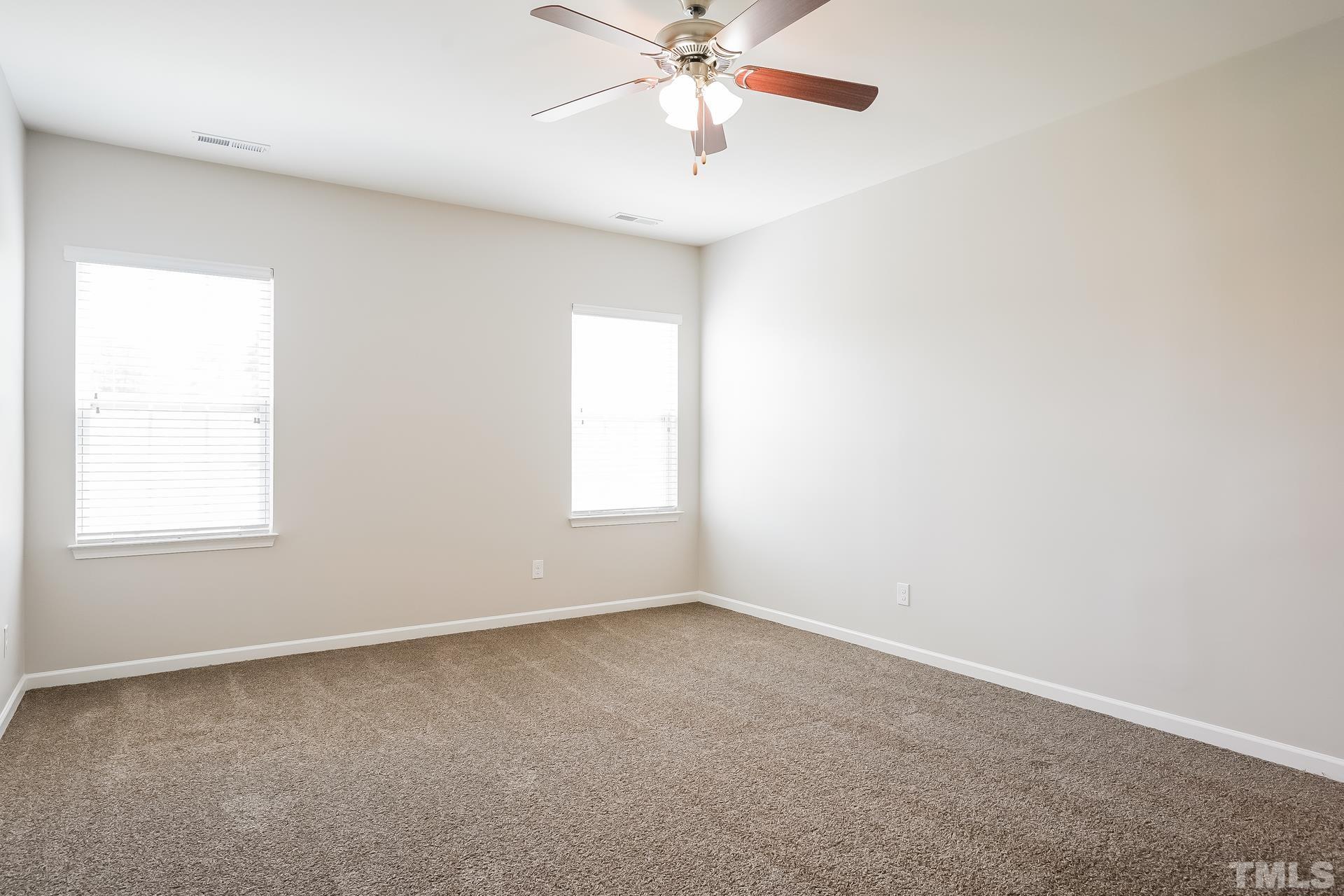 901 Rose Mallow Drive Zebulon, NC 27597 - Photo 10 of 15 an empty room with a window and a fan