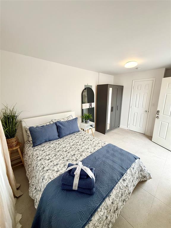 a bedroom with a large bed and a dresser