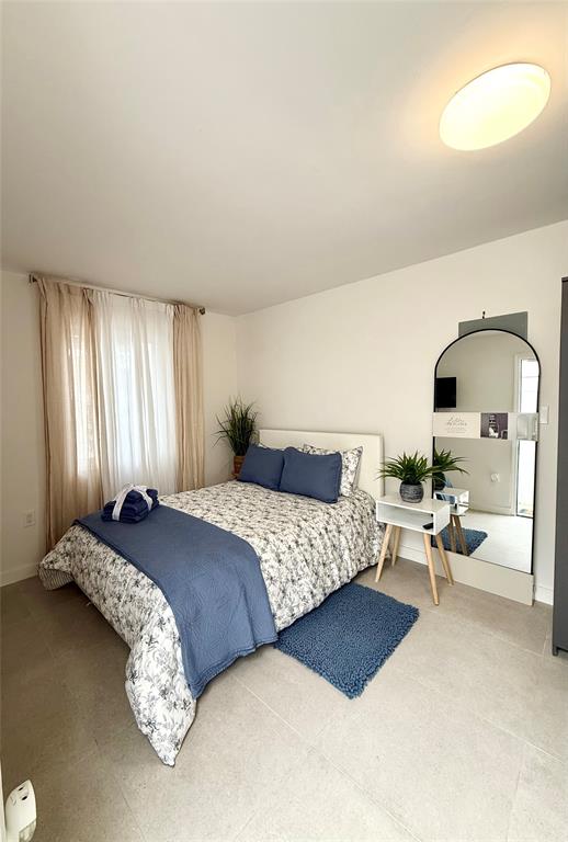 2420 Southwest 11th Street, Unit B Miami, FL 33135 - Photo 2 of 12 a bedroom with bed couch and window