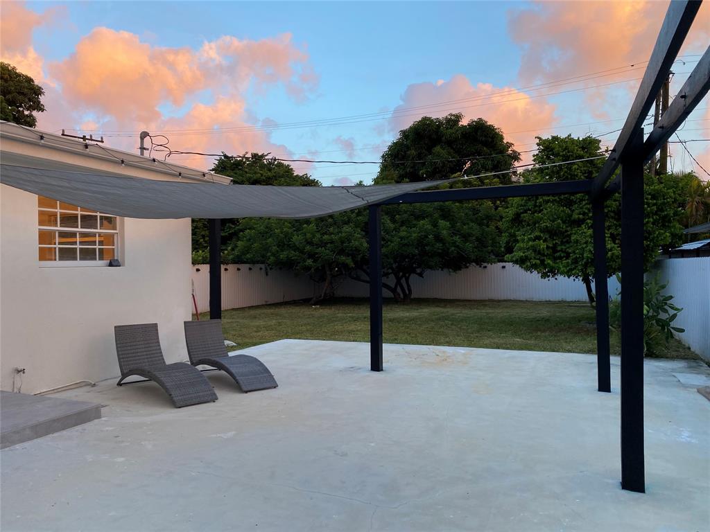 2420 Southwest 11th Street, Unit B Miami, FL 33135 - Photo 9 of 12 a view of backyard with a table and chair