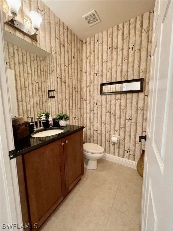 10816 Marble Brook Boulevard Lehigh Acres, FL 33936 - Photo 13 of 41 a bathroom with a sink a toilet and shower curtain