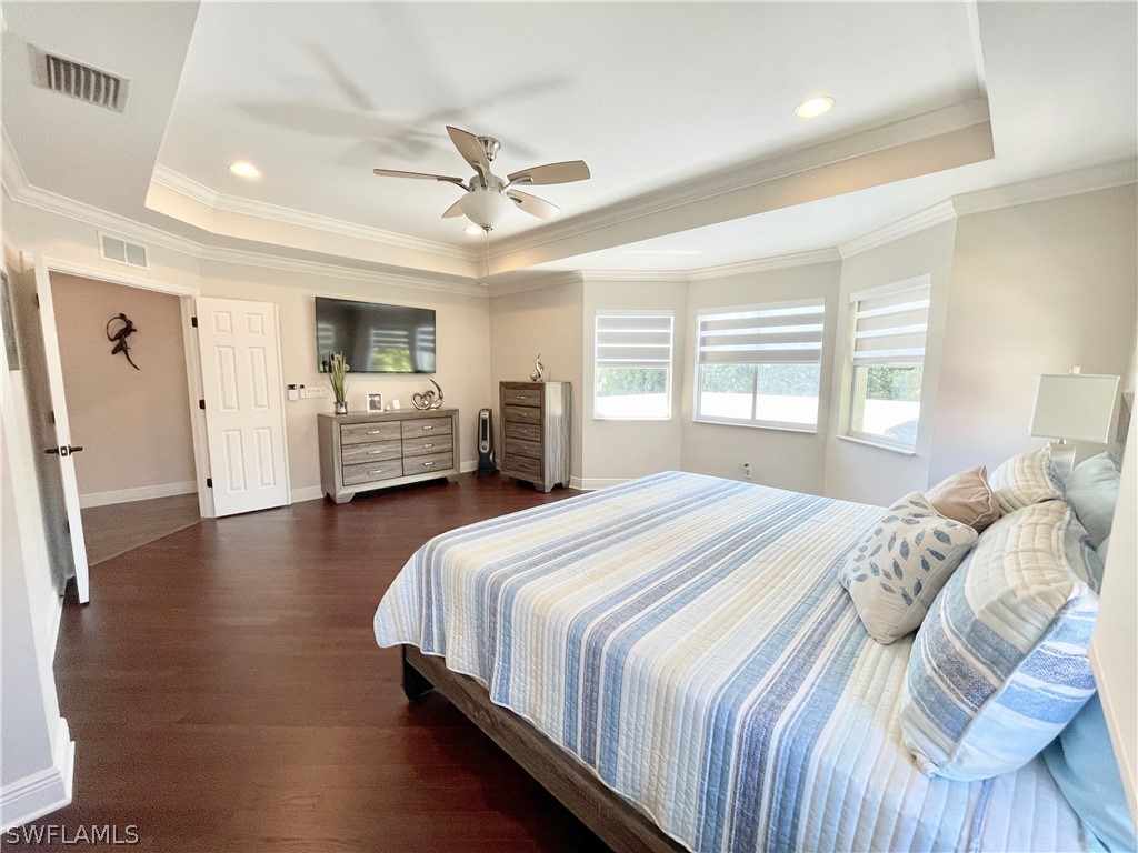 10816 Marble Brook Boulevard Lehigh Acres, FL 33936 - Photo 16 of 41 a bedroom with a bed and ceiling fan