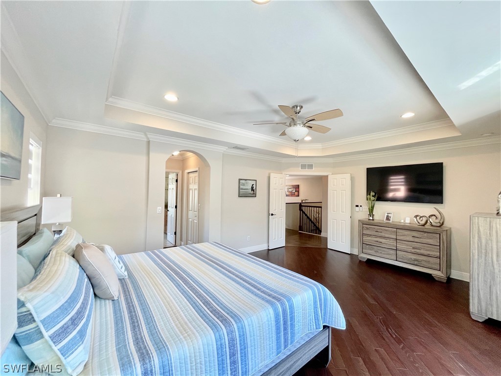 10816 Marble Brook Boulevard Lehigh Acres, FL 33936 - Photo 17 of 41 a bedroom with a bed and flat screen tv