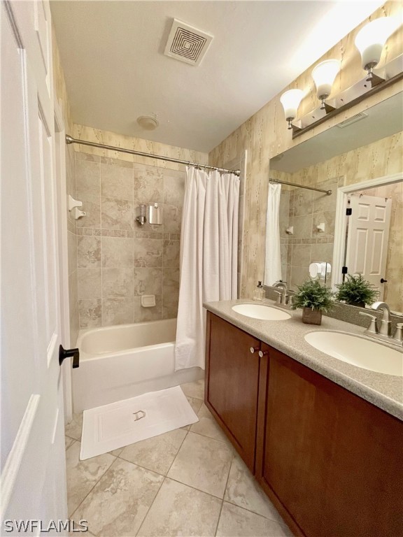 10816 Marble Brook Boulevard Lehigh Acres, FL 33936 - Photo 21 of 41 a bathroom with a bathtub sink double vanity granite tub shower and mirror