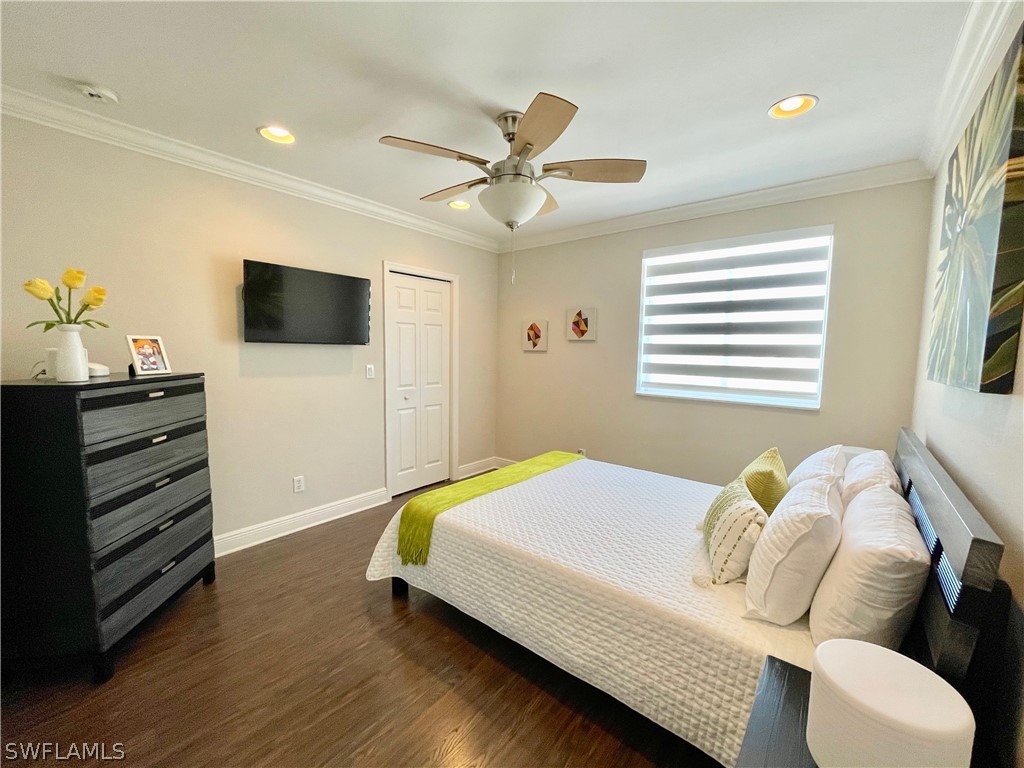 10816 Marble Brook Boulevard Lehigh Acres, FL 33936 - Photo 22 of 41 a bedroom with a bed and a flat screen tv