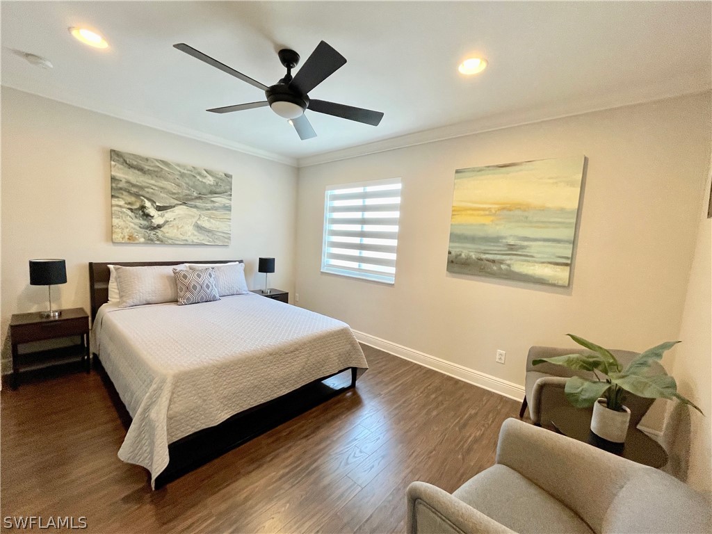 10816 Marble Brook Boulevard Lehigh Acres, FL 33936 - Photo 23 of 41 a bedroom with a bed and wooden floor