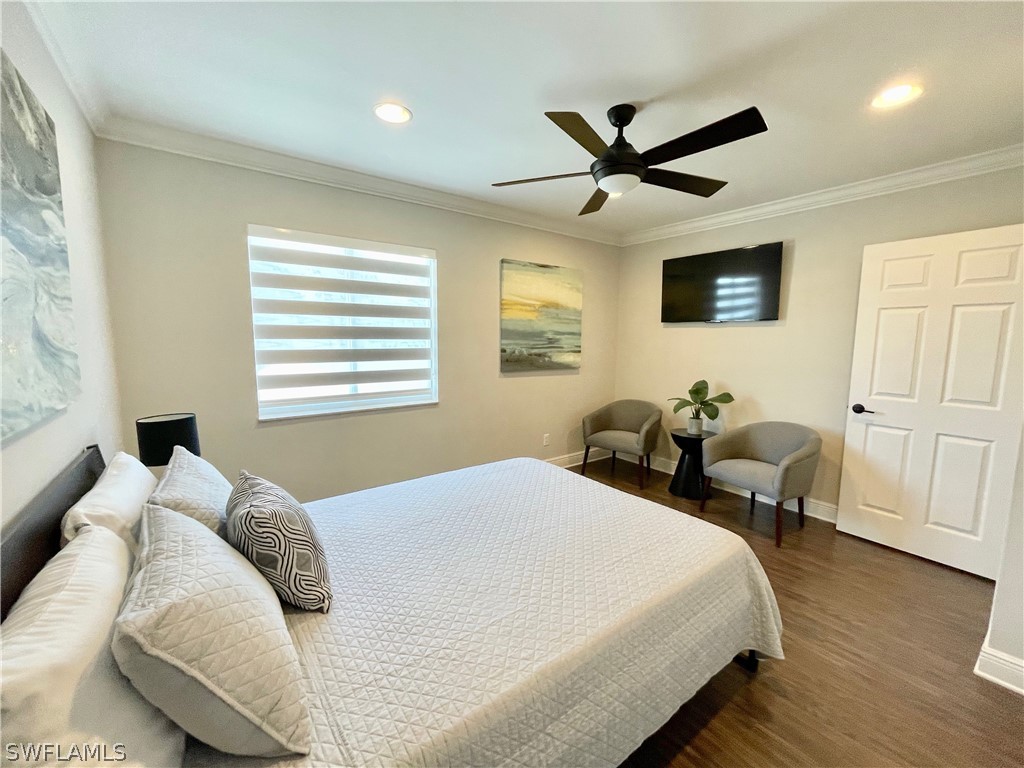 10816 Marble Brook Boulevard Lehigh Acres, FL 33936 - Photo 24 of 41 a bedroom with a bed and wooden floor