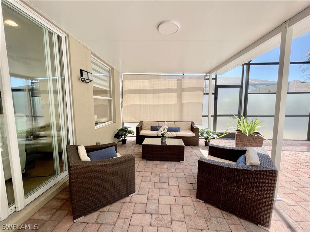 10816 Marble Brook Boulevard Lehigh Acres, FL 33936 - Photo 26 of 41 a living room with furniture and large windows