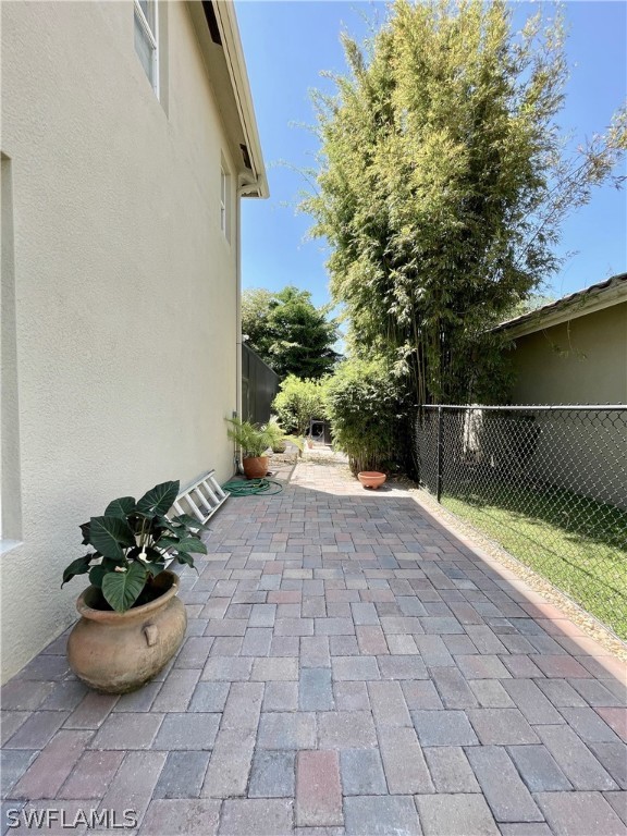 10816 Marble Brook Boulevard Lehigh Acres, FL 33936 - Photo 32 of 41 a view of a backyard with plants