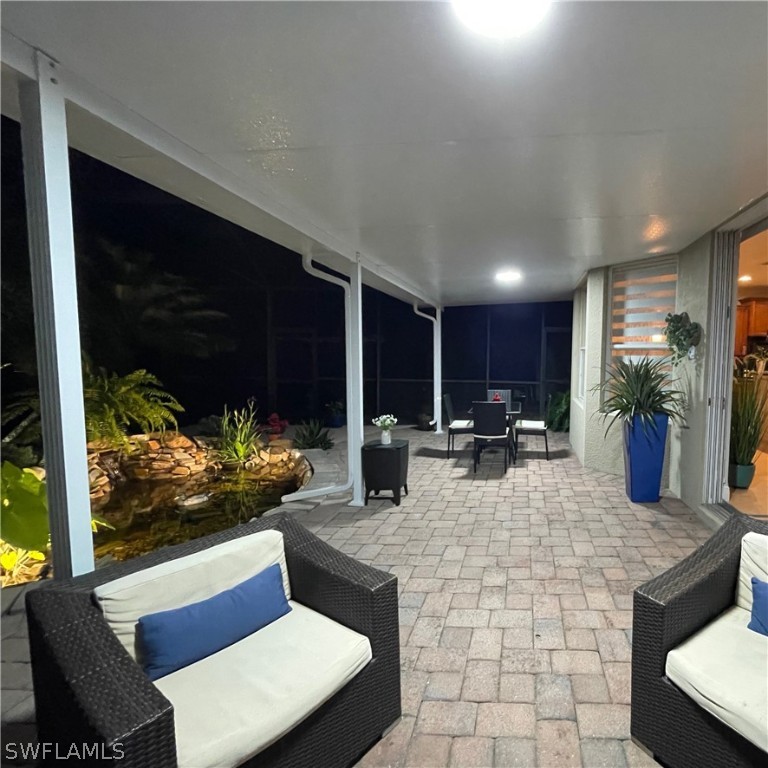 10816 Marble Brook Boulevard Lehigh Acres, FL 33936 - Photo 40 of 41 a living room with fireplace furniture and a potted plant