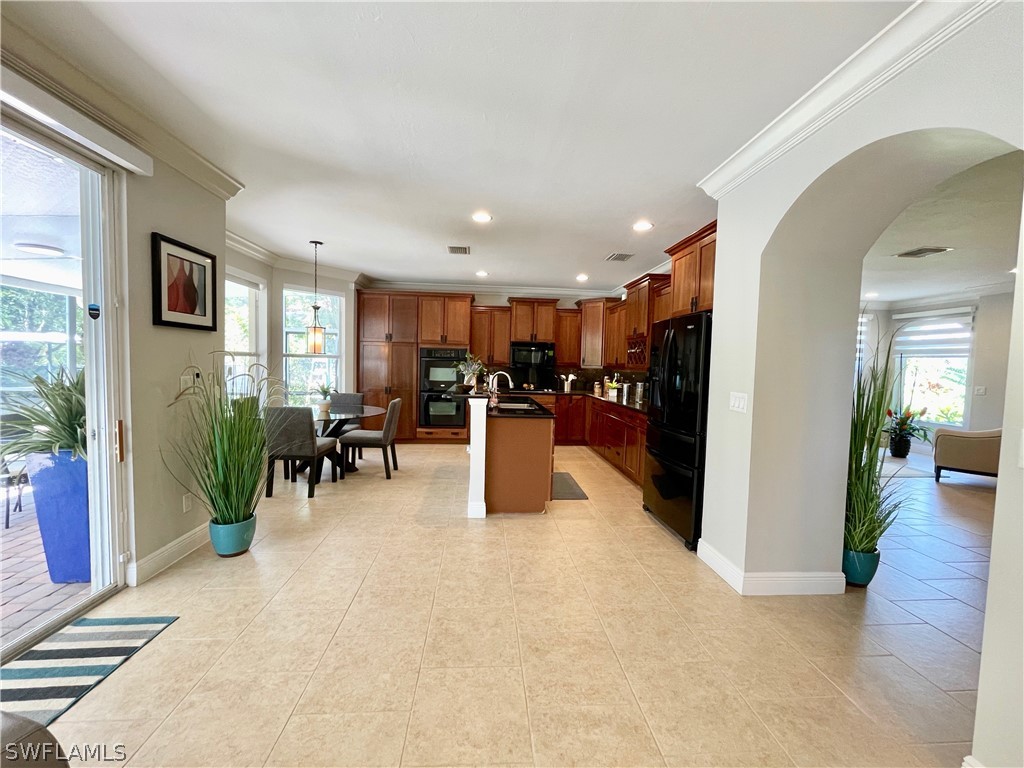 10816 Marble Brook Boulevard Lehigh Acres, FL 33936 - Photo 7 of 41 a lobby with furniture and a potted plant