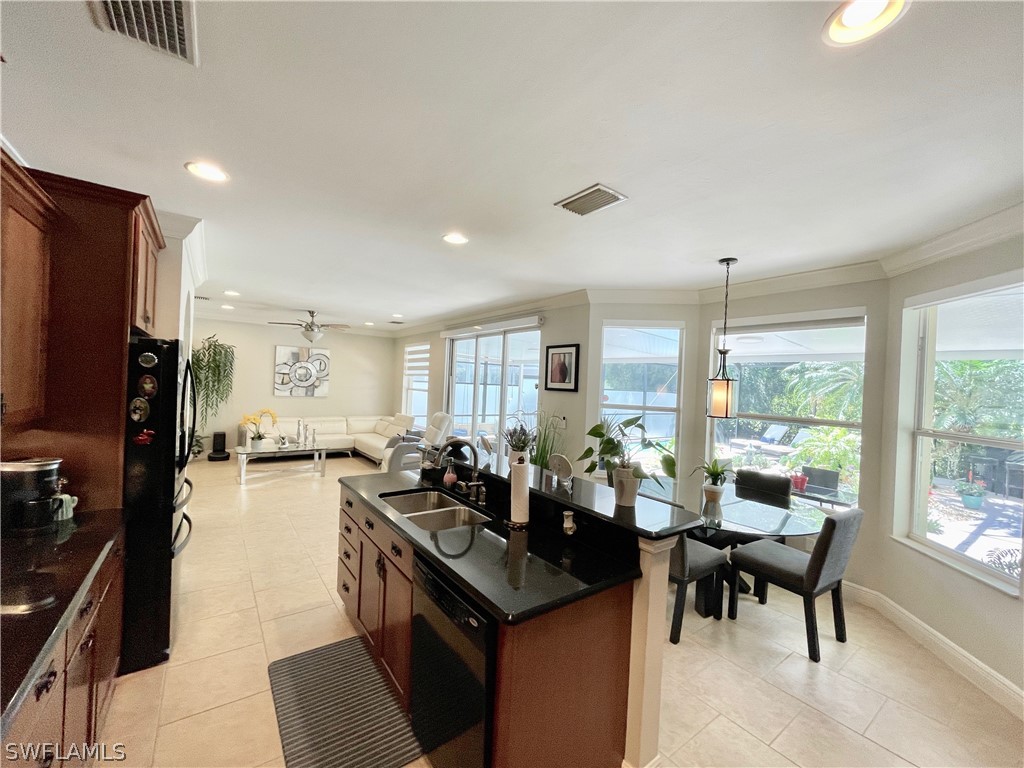 10816 Marble Brook Boulevard Lehigh Acres, FL 33936 - Photo 8 of 41 a living room with furniture and a flat screen tv