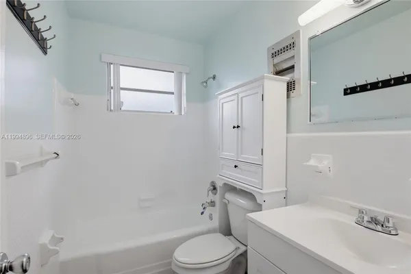 a bathroom with a sink toilet vanity and shower