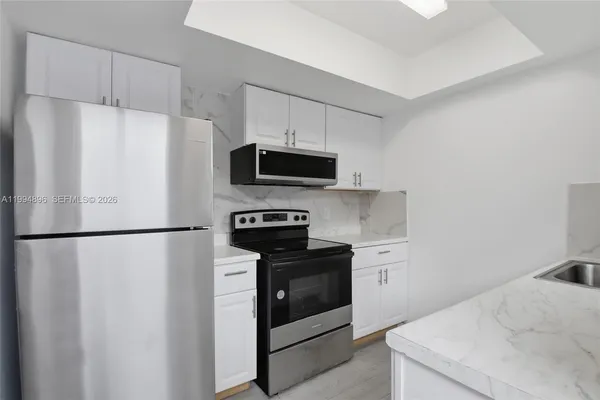 a white refrigerator freezer sitting in a kitchen