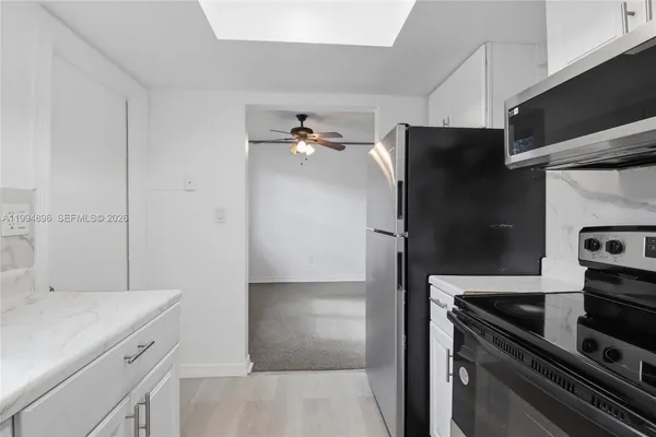 a kitchen with a refrigerator and a sink