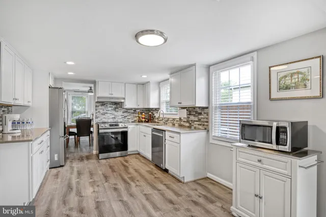 a kitchen with a sink cabinets and stainless steel appliances