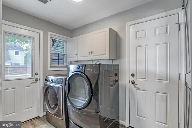 a view of a storage and utility room with washer and dryer