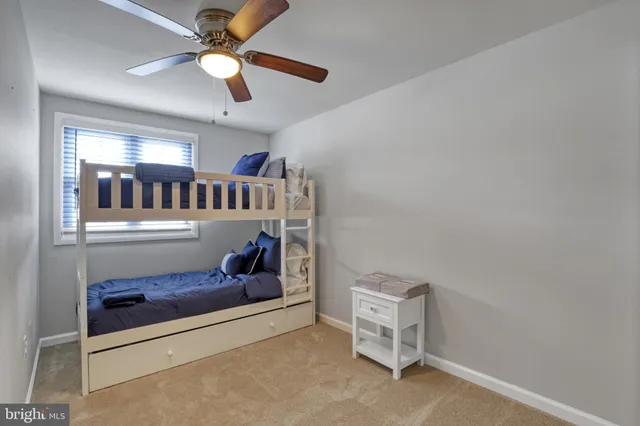 a living room with furniture and a ceiling fan