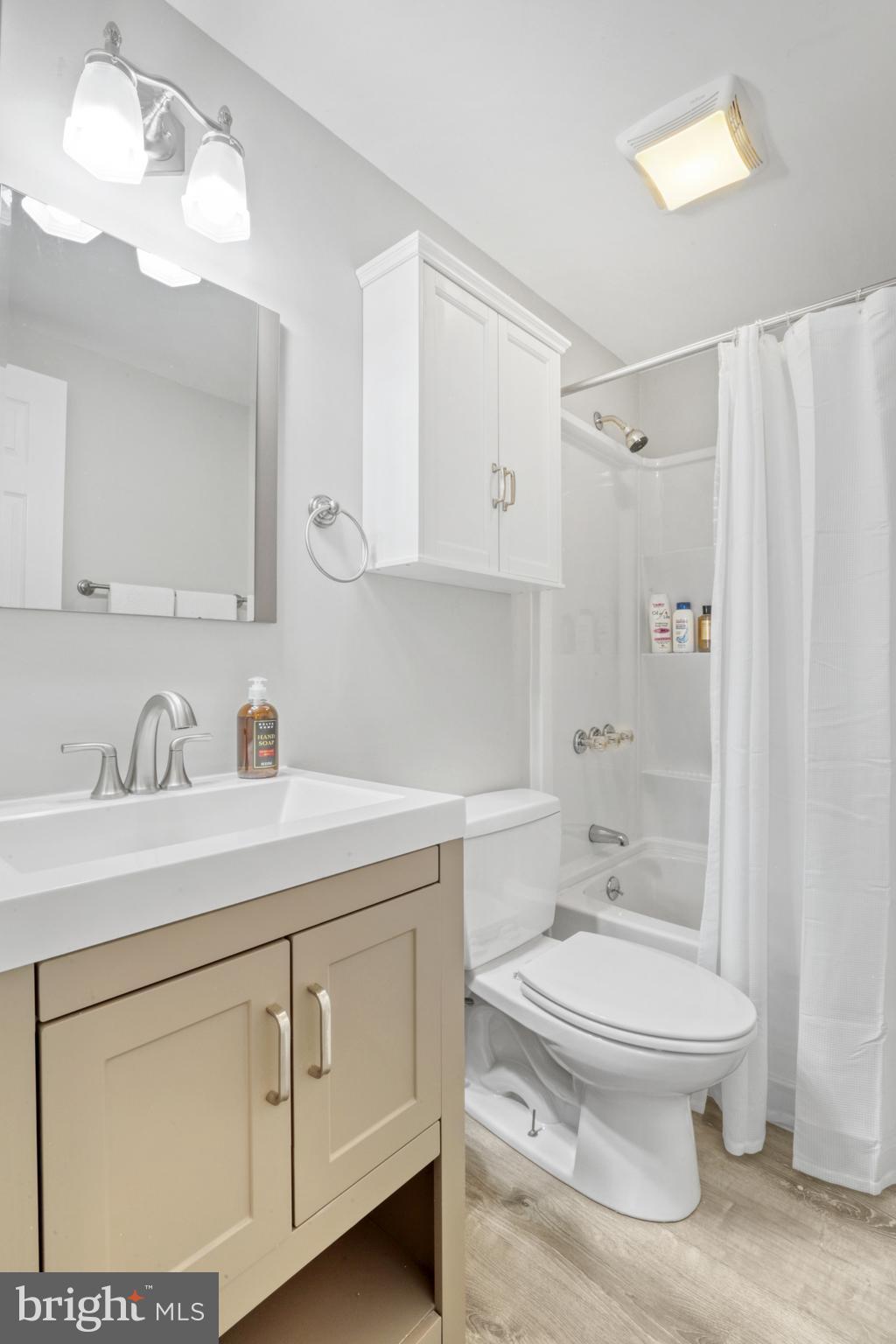 103 Cherry Tree Court Sterling, VA 20164 - Photo 22 of 32 a bathroom with a sink a toilet and a mirror