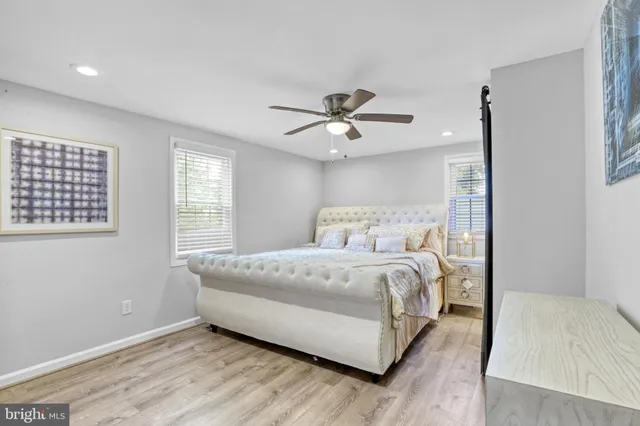 a bed room with a bed and a ceiling fan