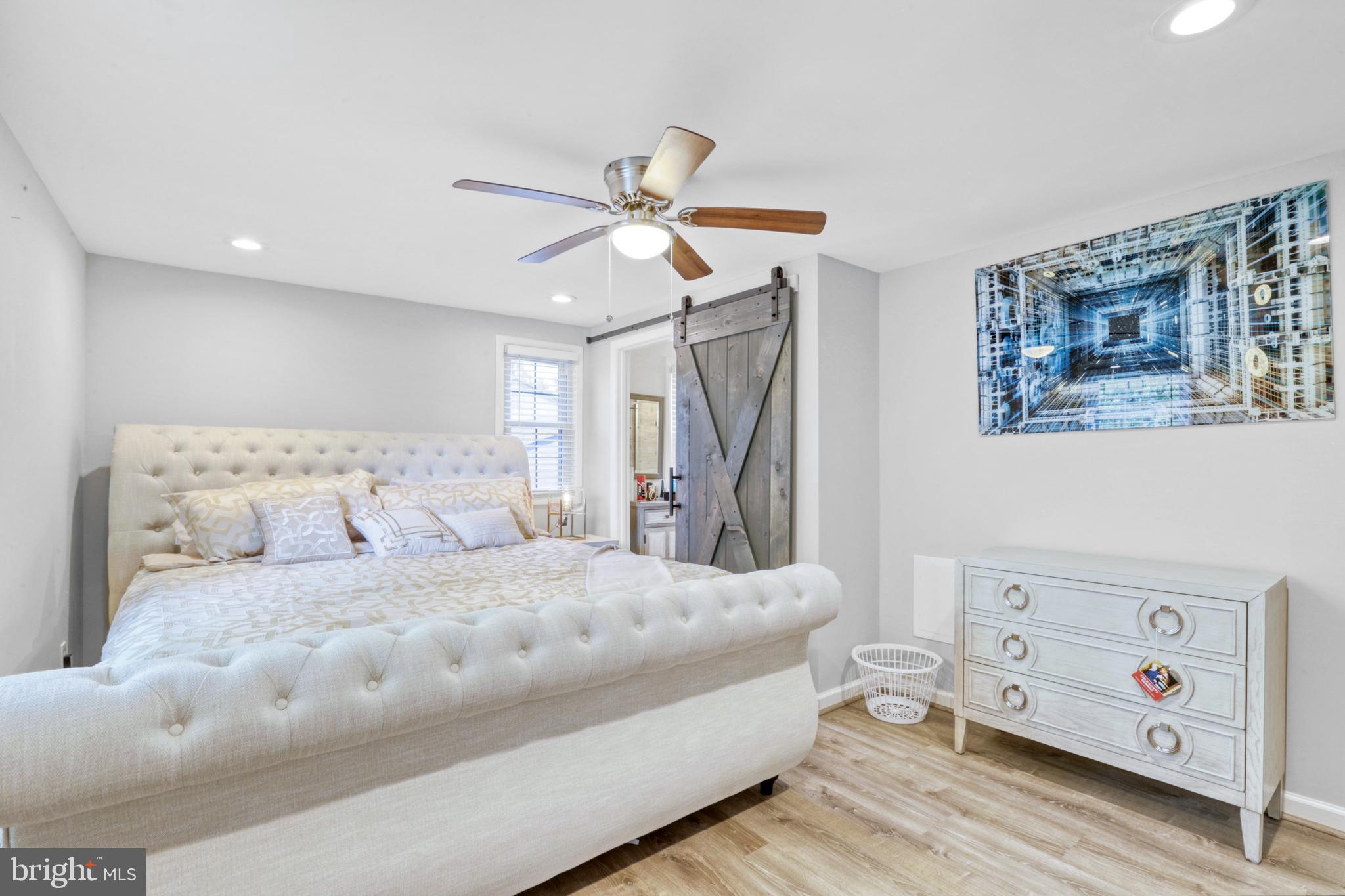 103 Cherry Tree Court Sterling, VA 20164 - Photo 27 of 32 a bedroom with a large bed and a chandelier