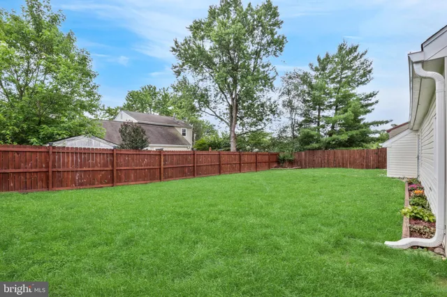 a view of a backyard with a wooden fence