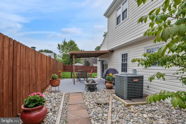 a view of a patio with table and chairs and potted plants
