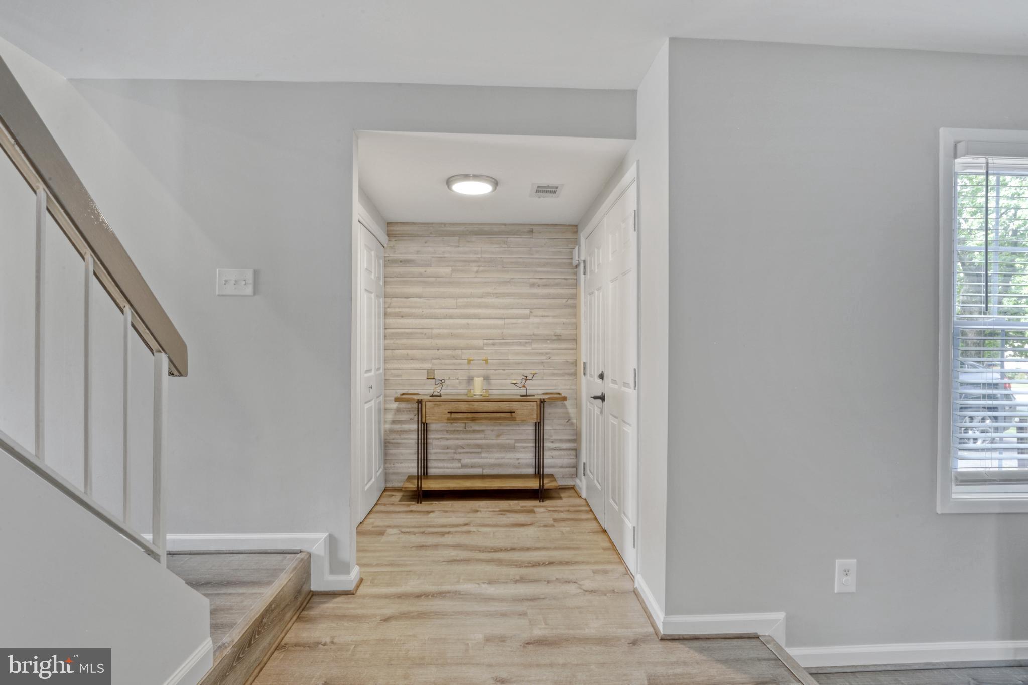 103 Cherry Tree Court Sterling, VA 20164 - Photo 4 of 32 a view of a hallway with wooden floor and staircase
